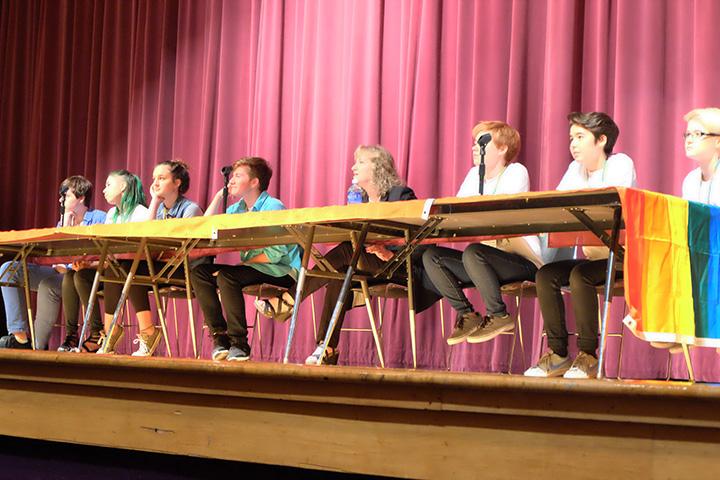 Panel members listen to questions from community members in the audience.