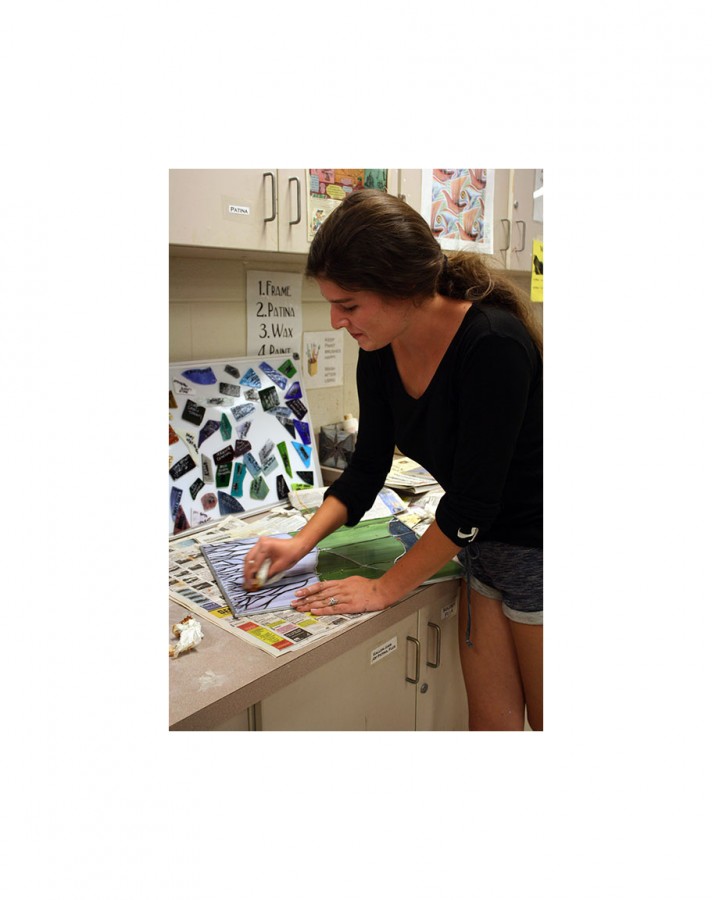 Student adds final touch to stained glass project