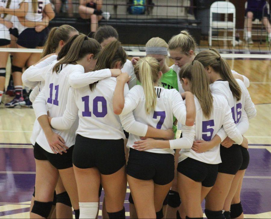 The volleyball team huddles up before Tuesday nights game