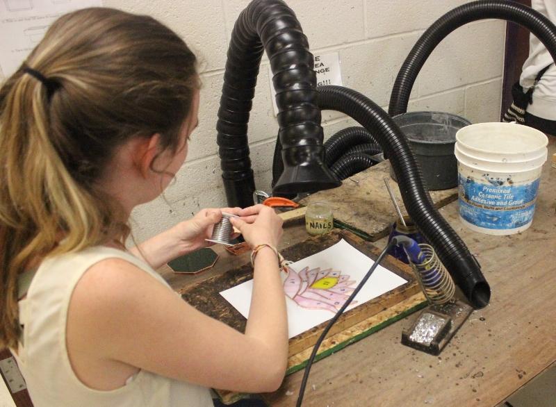 Sophomore Savannah Bruhn works on her jewelery box for Mrs. Berzins  stained glass class. This is their second class assignment. 