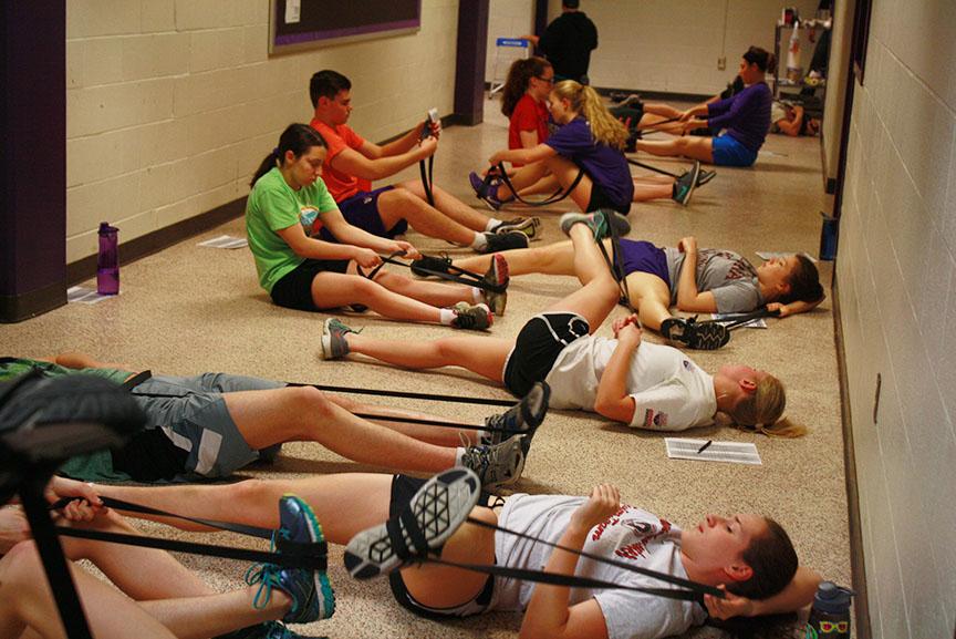 Athletes stretch before weights class