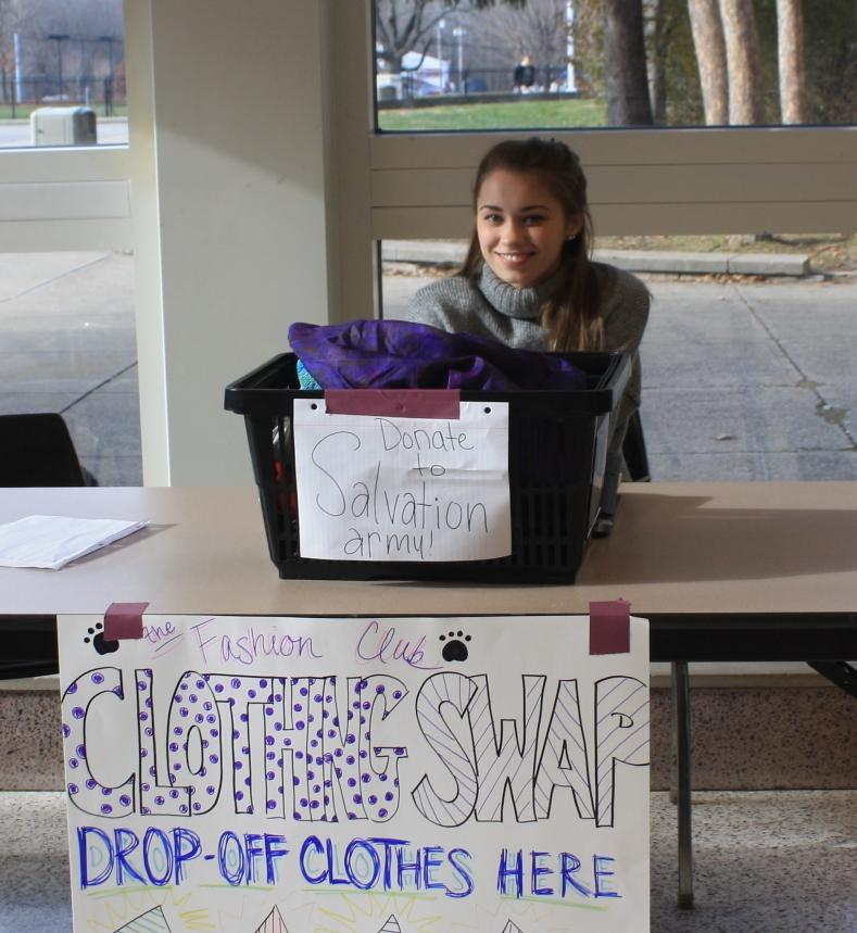 Fashion club member, Kristen Adams works during lunch to help advocate for the clubs upcoming clothes swap. Those who donate clothes are able to trade for another piece of clothing. Items that are not taken will be donated to the salvation army, the clothing swap will take place on December 19th during SRT and after school.