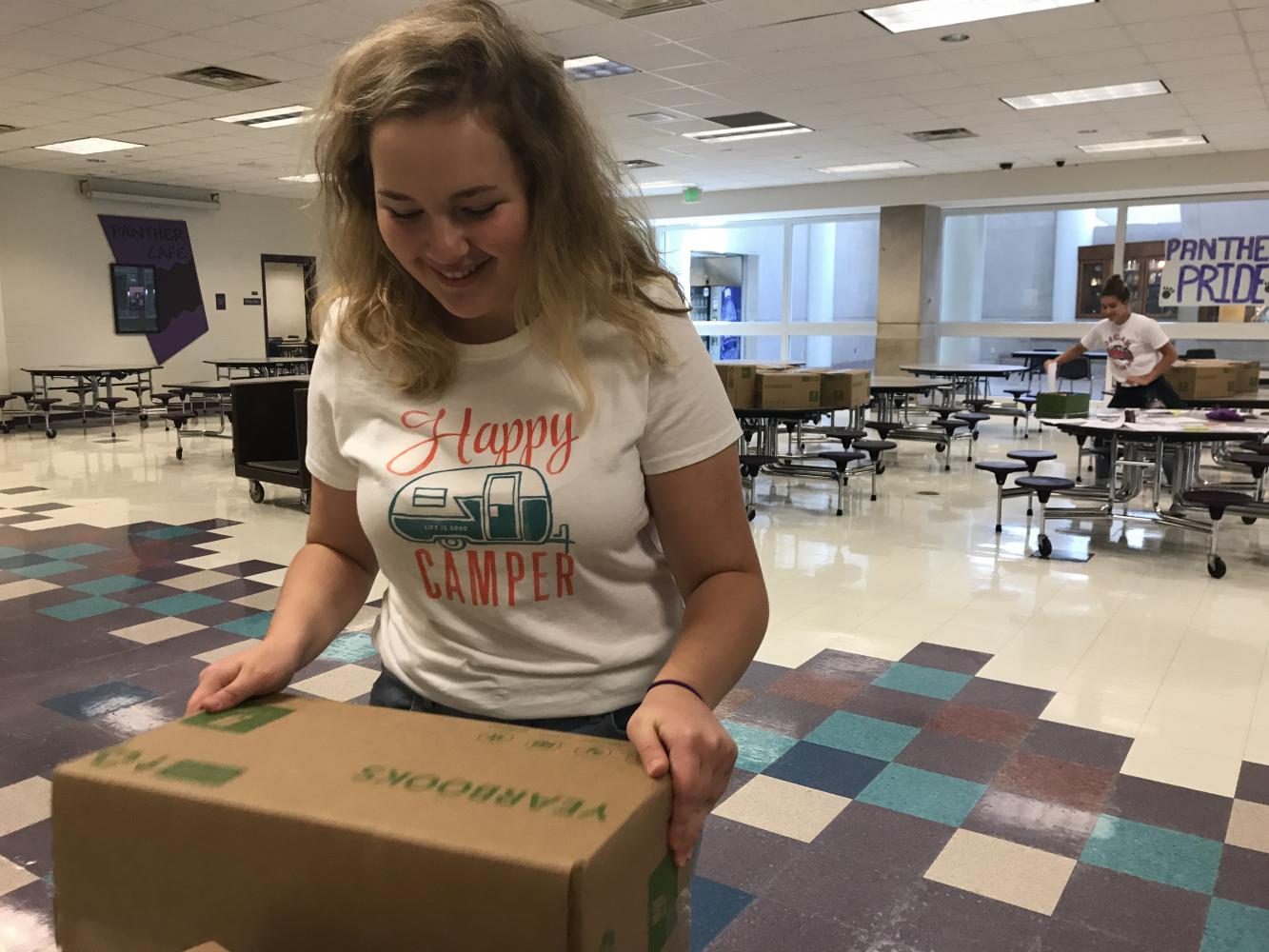 Senior Zoe Berenzstein helps organize yearbooks to be handed out to students