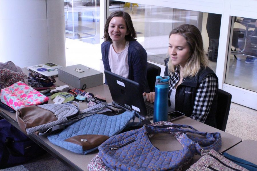Imprint project club members Layla Moore and Emily Witsman speak to a potential customer. The Imprint project sold fair trade goods this week during lunch to help stop human trafficking. 