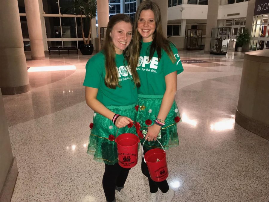 Junior execs Brittney Allen and Caroline Conrad collect admission fees for Dance Marathons first karaoke night last night and sport matching Christmas outfits.