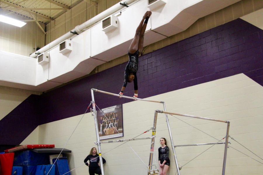North's Brittany Laffoon swings up during her bar routine.
