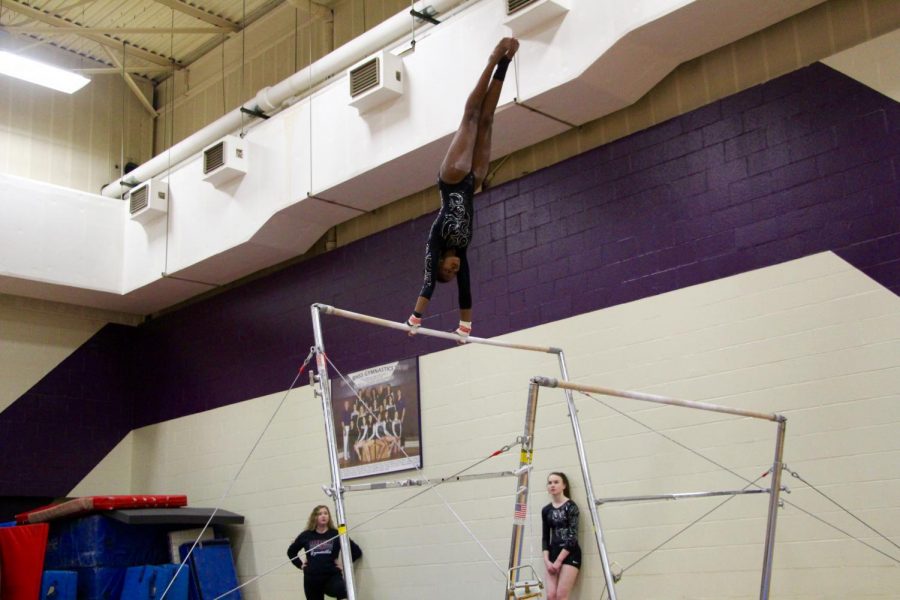 Norths Brittany Laffoon swings up during her bar routine.