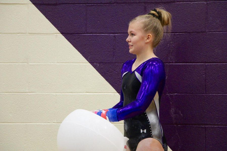 South's Delaney Blubaugh chalks up her hands before she begins her beam routine.
