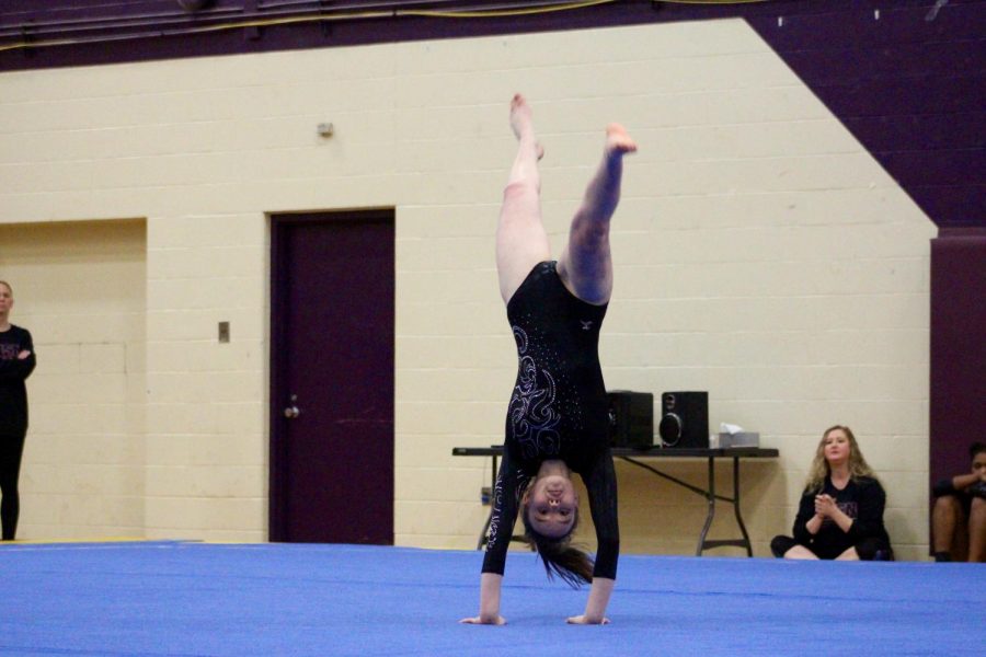 Norths Sarah Bickford preforms a back hand spring during her floor routine.