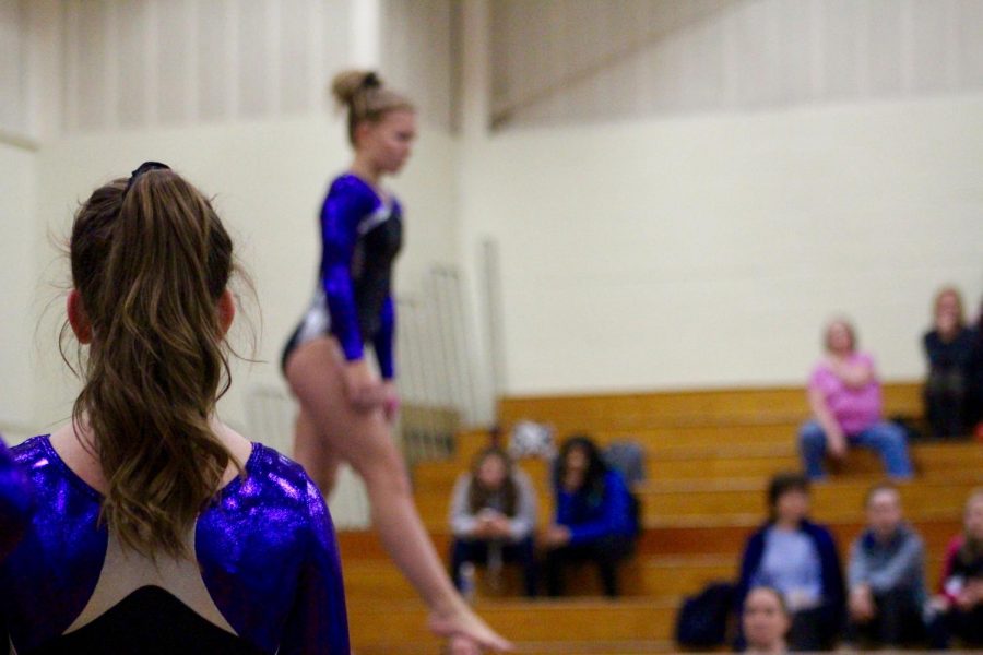 South's Carissa Moore watches as teammate Delaney Blubaugh preforms on the beam.