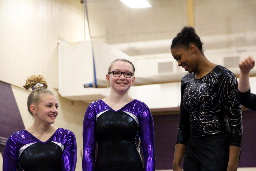 Souths Hailey Landis (left) and McKenzie Hales stand next to North winner Brittany Laffon on the poduim for the beam event. 