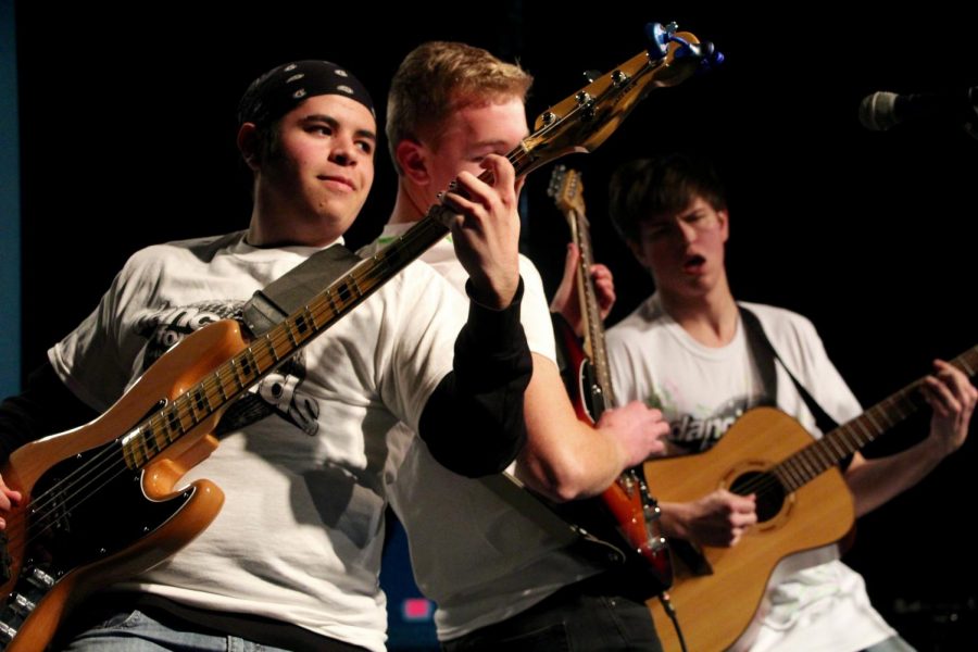 Elm Heights Band members Daniel Deckard and Hank Ruff go back to back while performing a song.