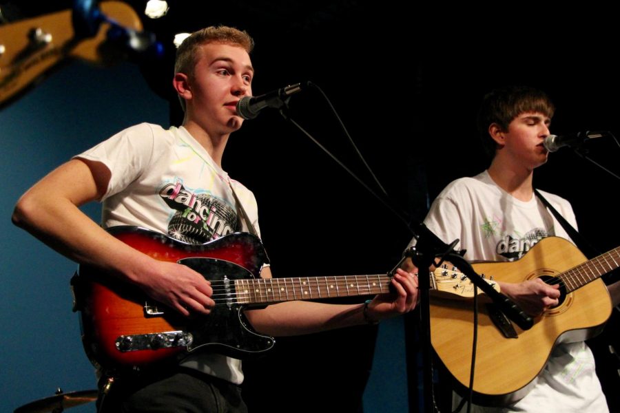 South graduate and Elm Heights Band member Hank Ruff sings and plays guitar during the performance.