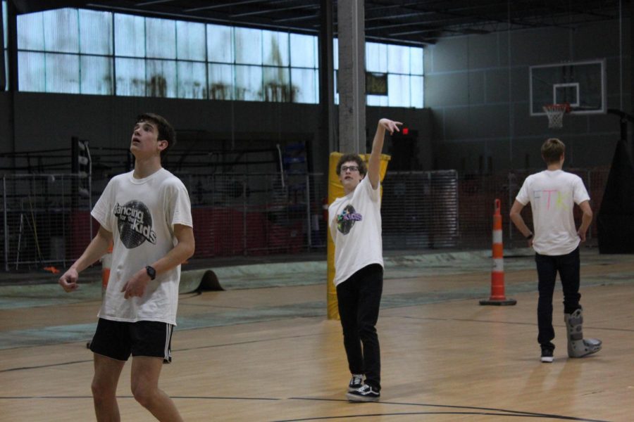 Junior Executives Scott Grabowski and Alan Morris play basketball.