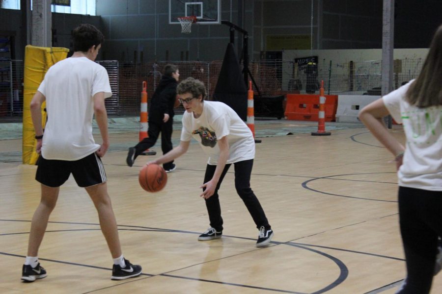 Junior Executives Scott Grabowski and Alan Morris play basketball.