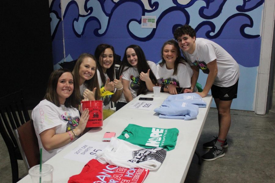 South junior executives pose at the merchandise table.