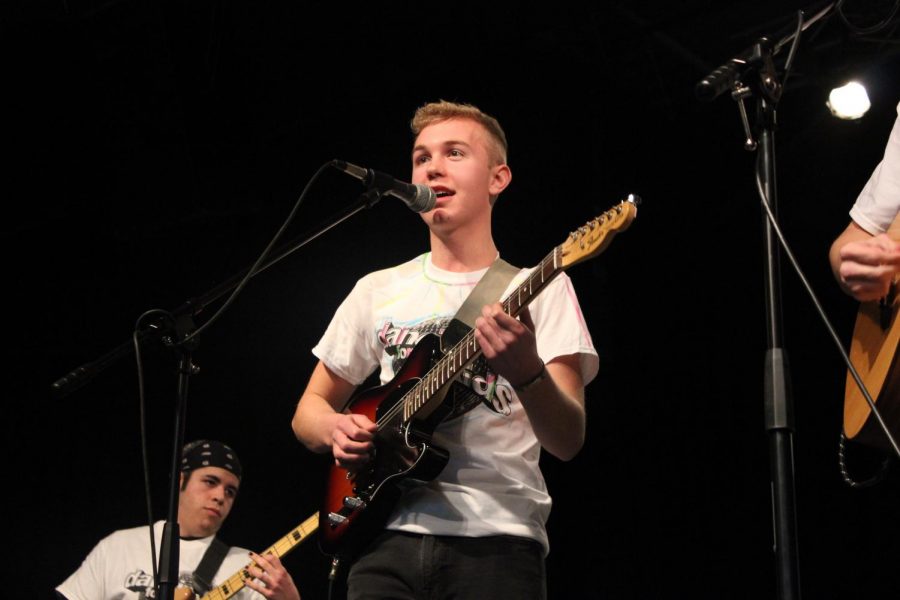 South graduate and Elm Heights Band frontman Hank Ruff sings and play guitar during Red Hot for Riley.