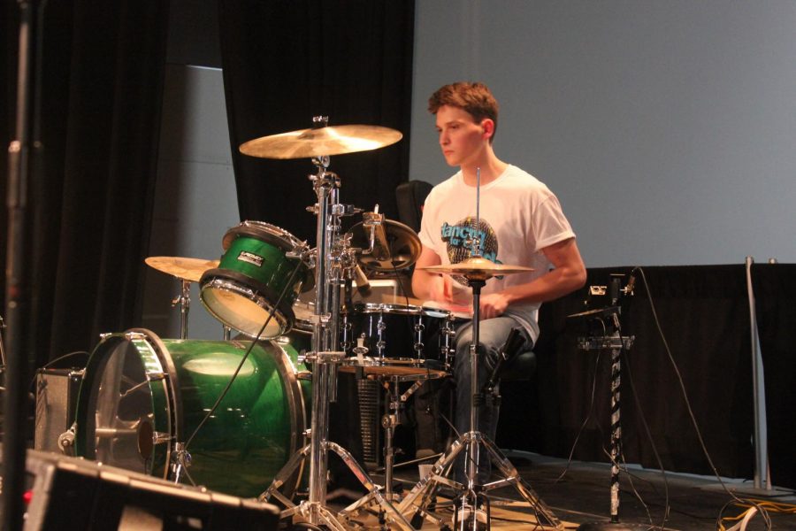 South graduate and Elm heights band member Devon Rigali plays drums during the band's performance.