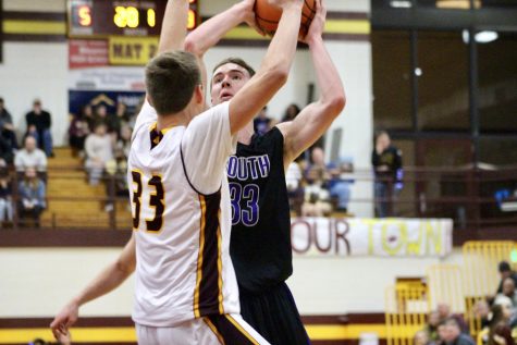 South's Chance Coyle (33) drives against North's Ethan Vencel (33). Coyle had a game high 29 points and scored more points than North's entire team combined. 