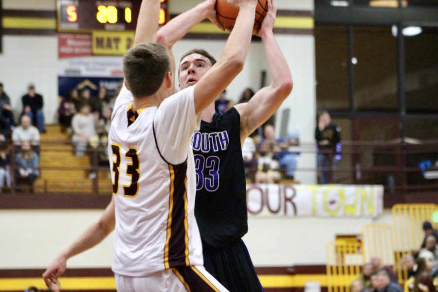 South's Chance Coyle (33) drives against North's Ethan Vencel (33). Coyle had a game high 29 points and scored more points than North's entire team combined. 