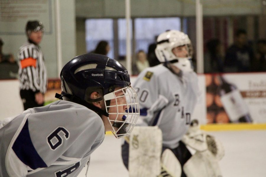 Bloomington's Sam Burris (6) wathces a face off.