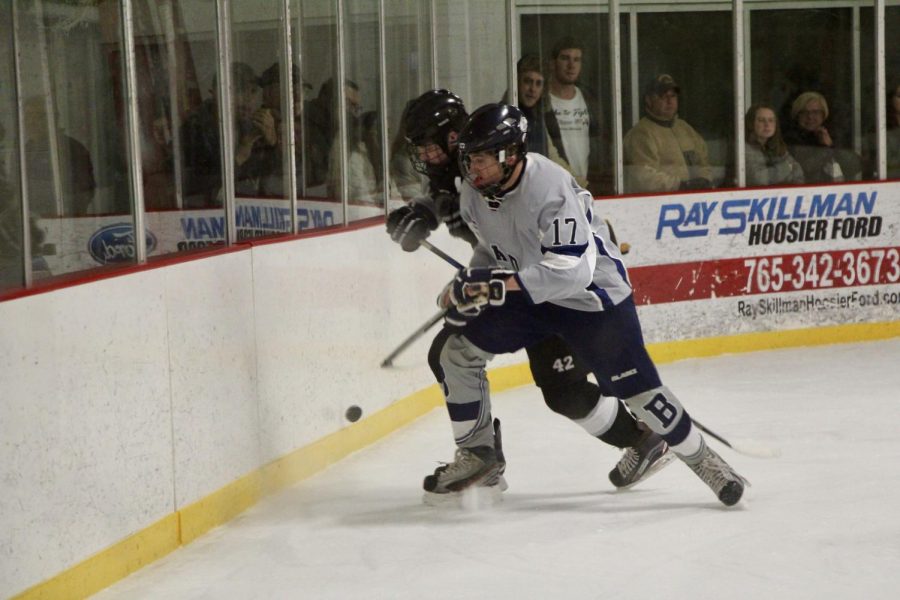 Bloomington's Anthony La Bella (17) fights for possesion against Central's Rhye Helt (42). 