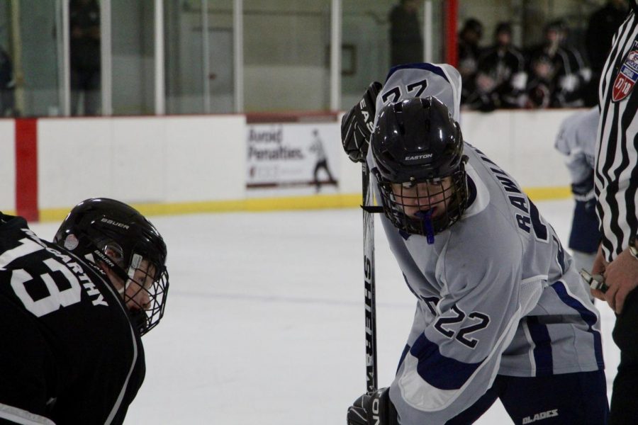 Bloomington's Austin Rawlins (22) prepares for a face off against Central's John McCarthy (13).