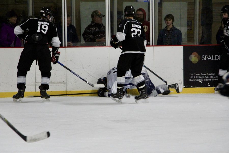 Bloomingtons Ryan Hunt (16) falls whil fighting for the puck.