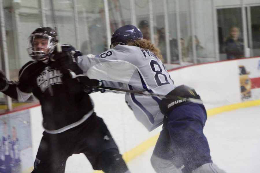 Bloomington's Sam Franklin (88) shoves a Central Indiana opponent.