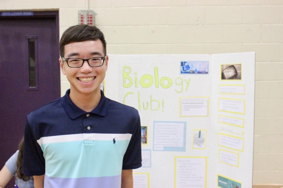 Junior+Andy+Chang+stands+in+front+of+his+Biology+club+poster.
