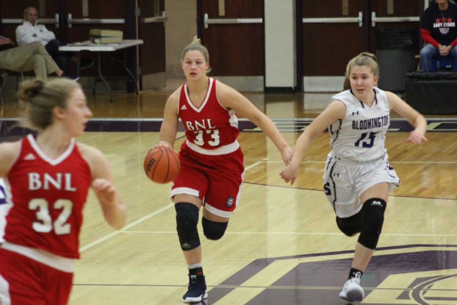 Junior Clara Voskuil (15) chases and guards BNL senior Jorie Allen (33)