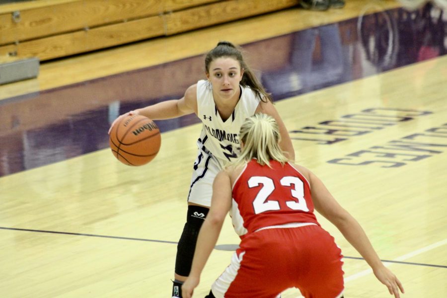 Senior guard Addy Blackwell (21) holds the ball as she sets up a play for the team