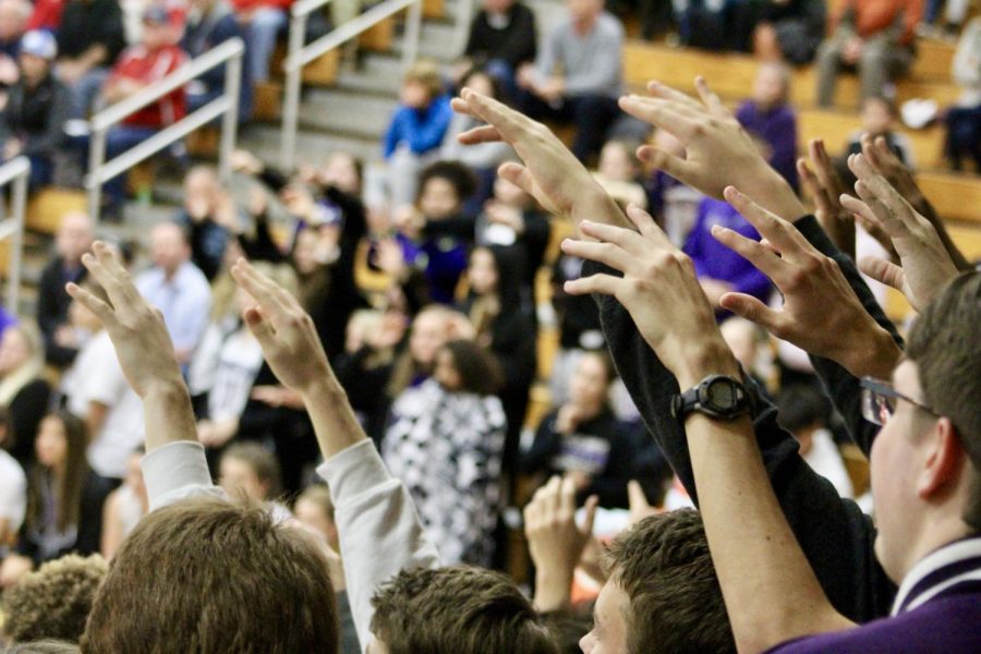 The student section hushes and raises their hands as they await a free throw from Anneke Furr (1)