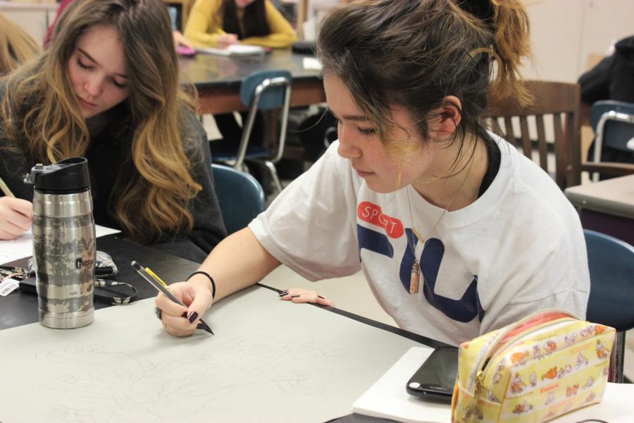 Seniors Erin Hardy (left) and Jack Owens (right) work on projects for their AP 2D Art class