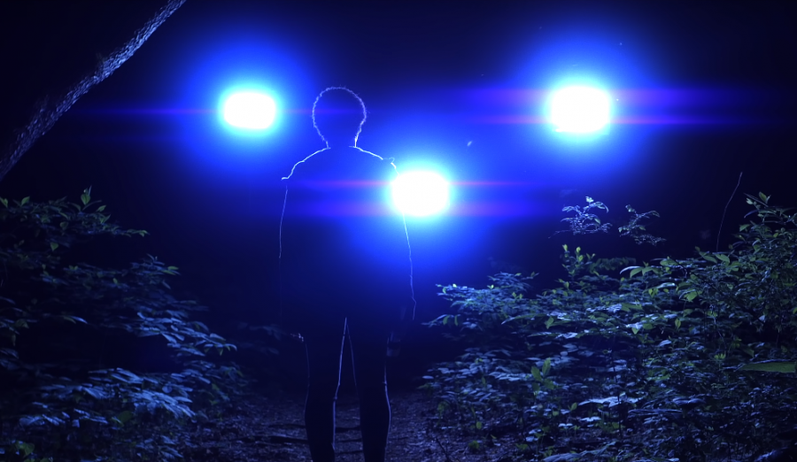 Samantha (Tamara Brown) stands in front of UFO lights. (1:50)
