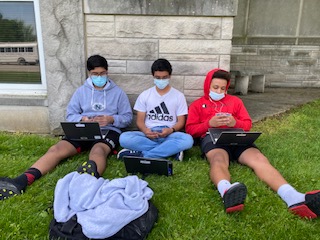 Juniors Aatif Rana, Nayib Hogan and Che Hogue enjoy the sunny spring weather.