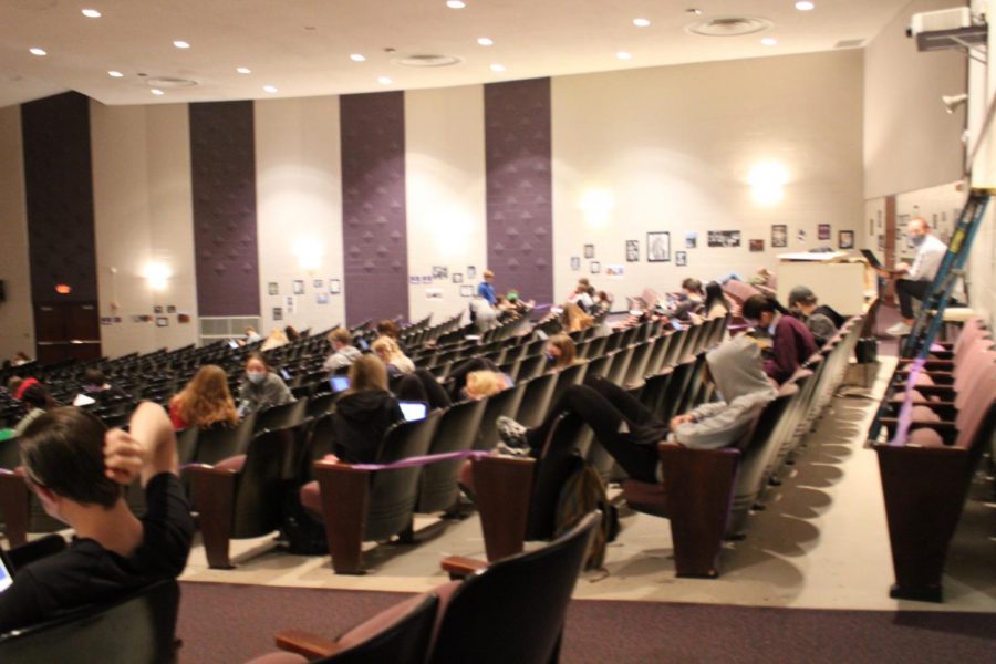 Students from classes without guest teachers sit in the auditorium.