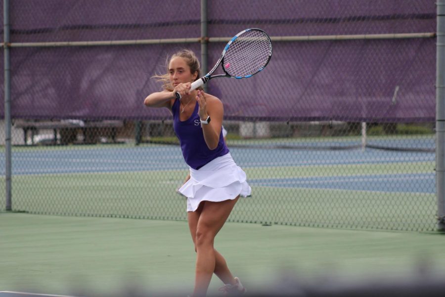 Junior Riley Walker receives serve in 2 doubles