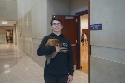 Carson Bohall, a sophomore, poses with a chicken from the agricultural career fair