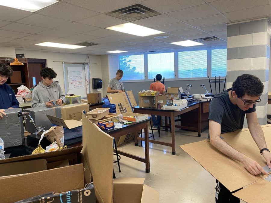 Seniors Toby Thomassen, Mitchel Lyles, Joeseph Merkley, and Shung Patel are hard at work making their cardboard boats.