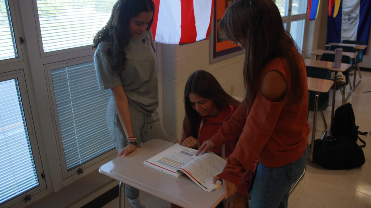 Sophomores Ana Guirado, Carlota Campos, and Lia Reina collaborating during a Spanish class assignment 