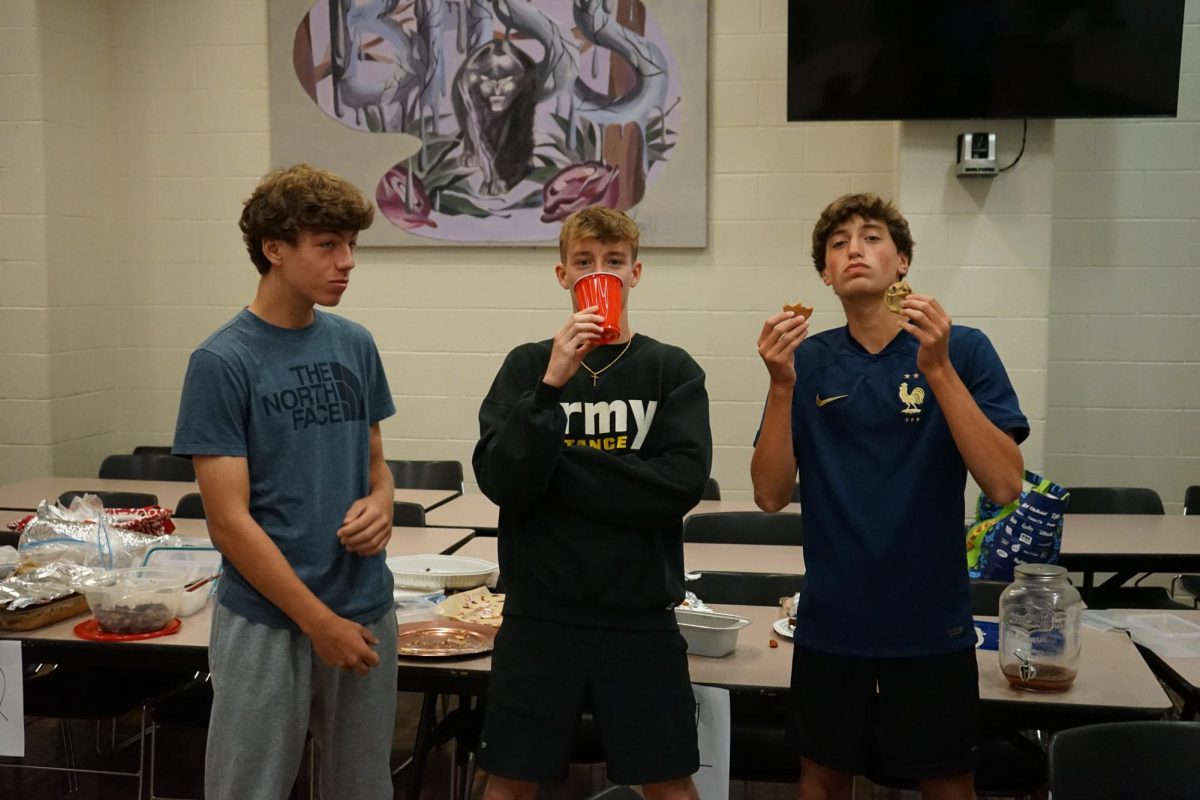 Freshmen Adrian Dusleag, Evan Gales and Senior Ryan Rheam enjoy cultural foods