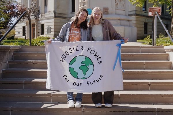 Hoosier Power Energy climate strike organizers, sophomore Alice Racek (left) and freshman Lydia Arnold (right) display a banner in support of Fridays for Future’s 2024 Global Climate Strike at the Monroe County Courthouse on Sunday afternoon
