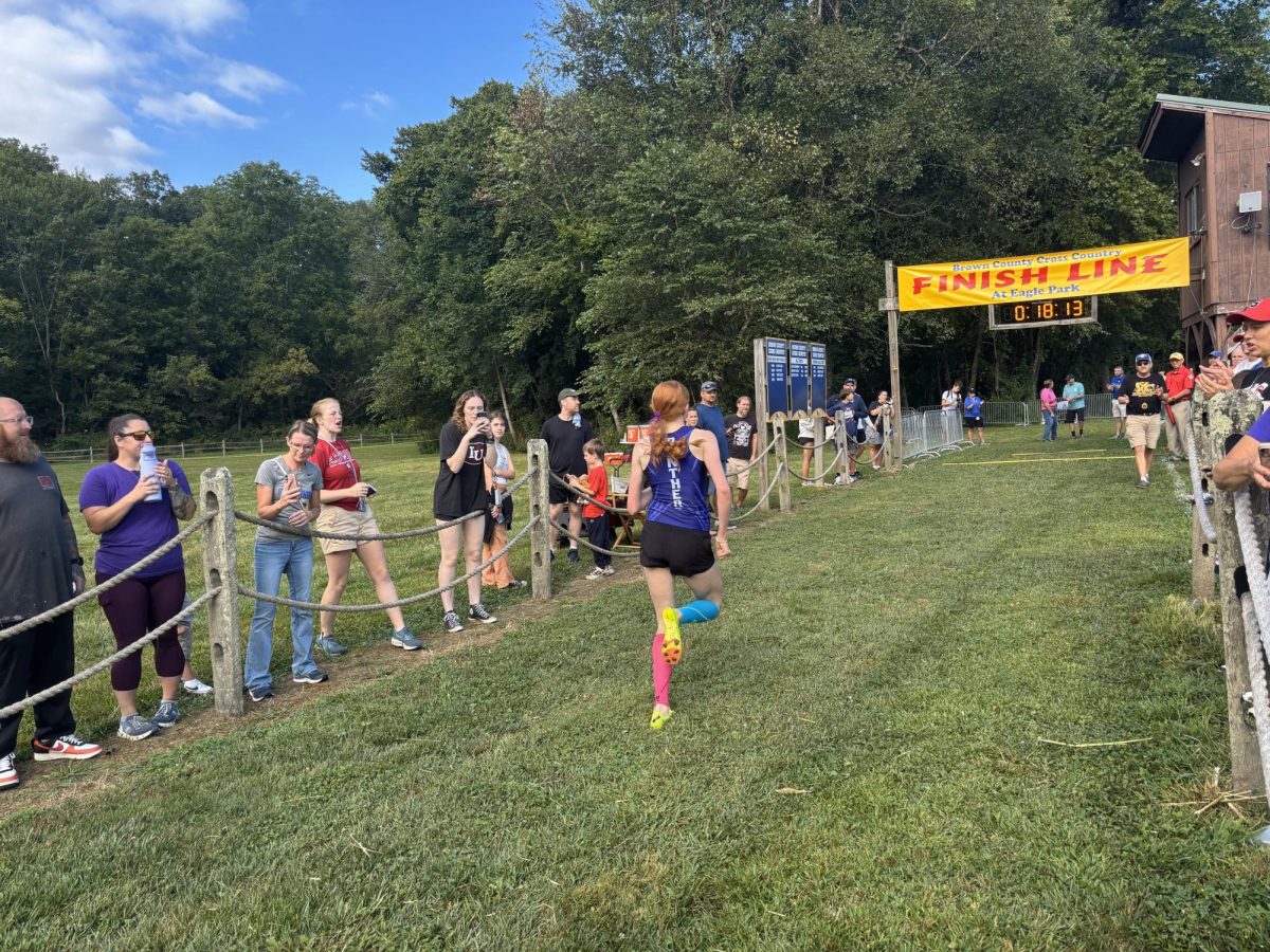 South's Lexi Kollbaum finishes first with a time of 18:15.7, followed by Jasmine Martioglio (3rd) and Aurelia Martioglio (4th).