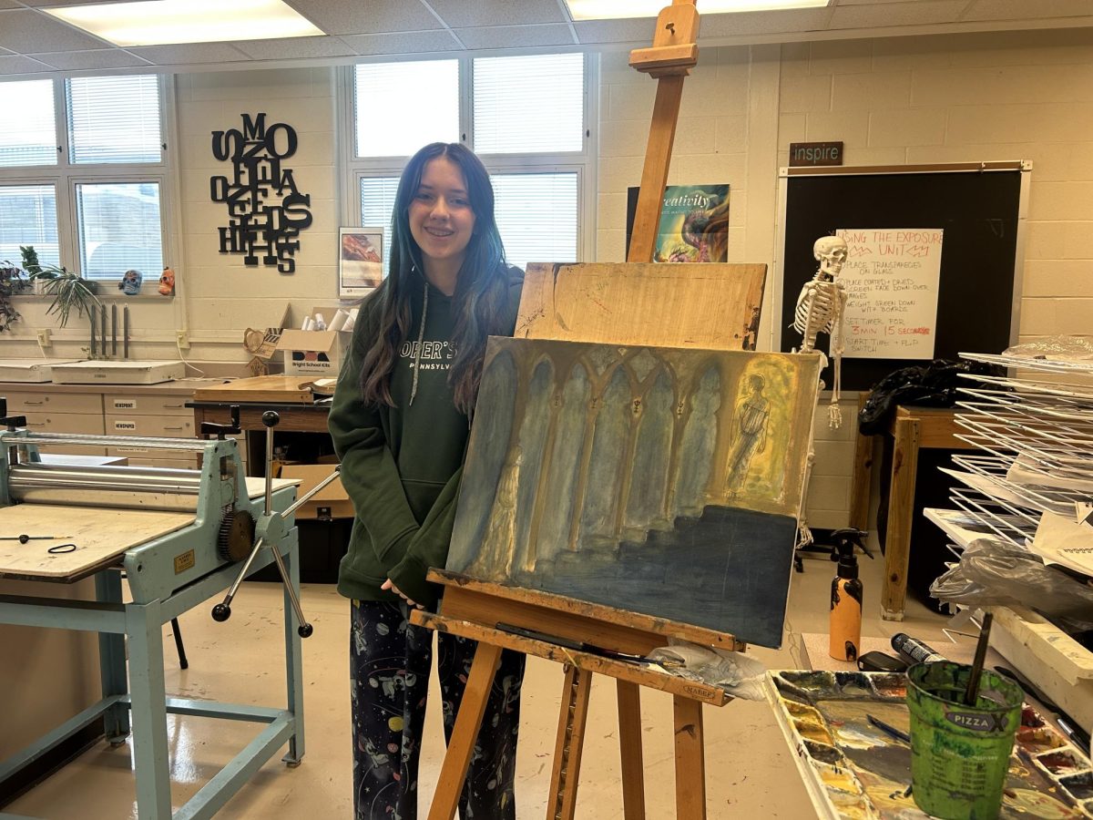 Junior Mackenzie Bryant works on a painting for AP Art class
