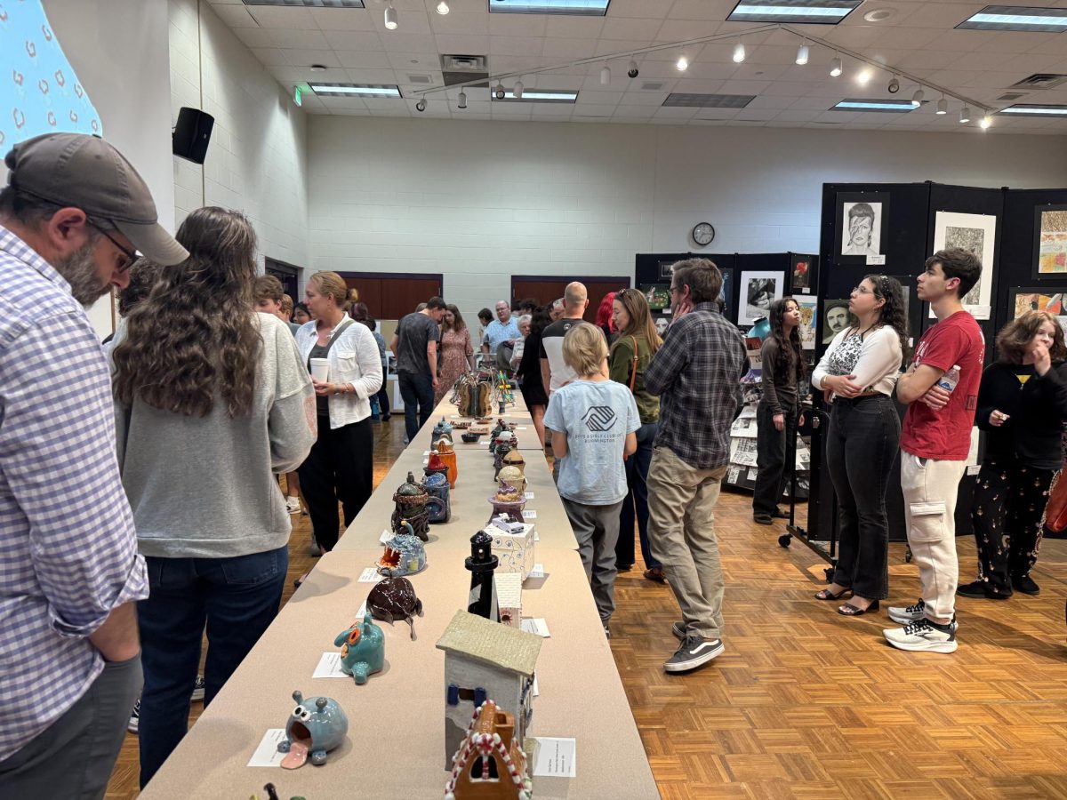 Visitors peruse student artwork at Fine Arts night on April 22.