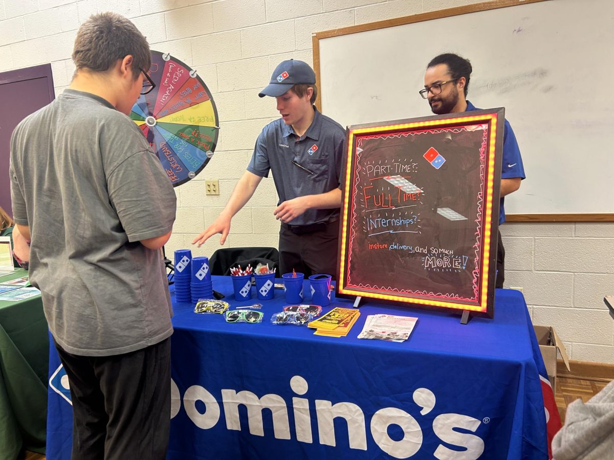 Students check out the Domino’s Pizza table at the Employment Fair